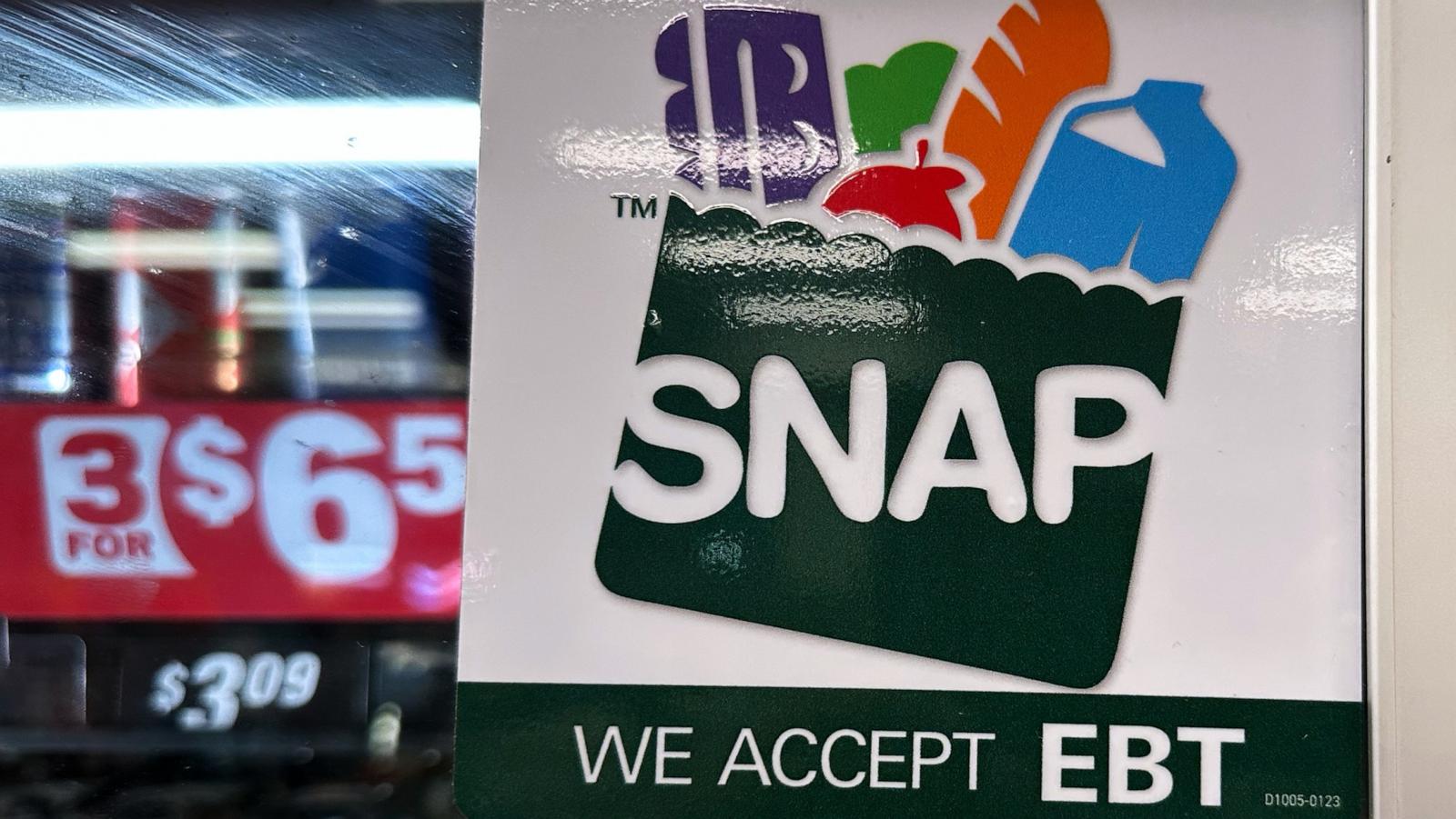 A grocery-store window sign reading SNAP and WE ACCEPT EBT.